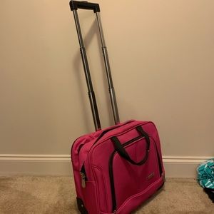 Pink rolling carry on bag